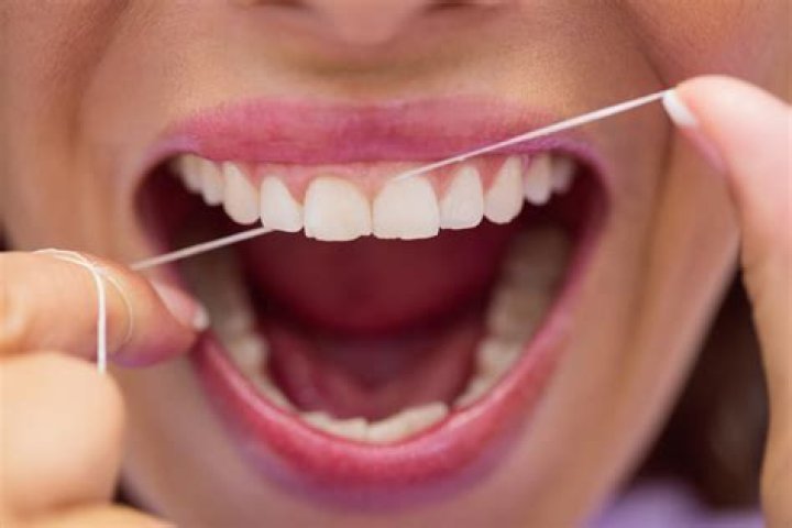 Are you supposed to floss under gums?