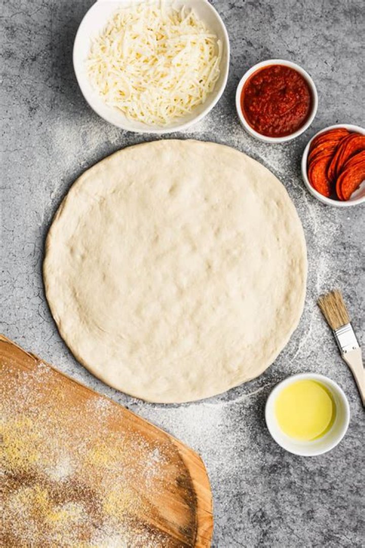 Do I cook pizza dough first?