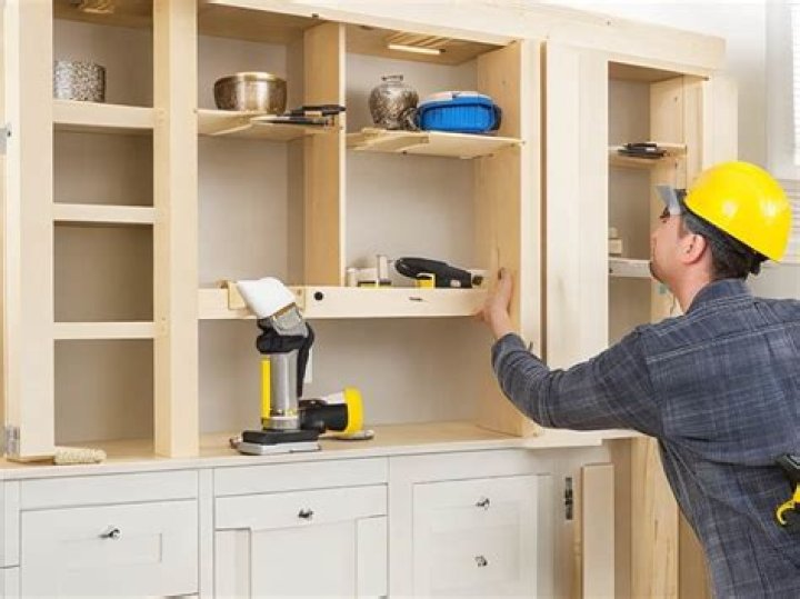 How are kitchen cabinets attached to the wall?