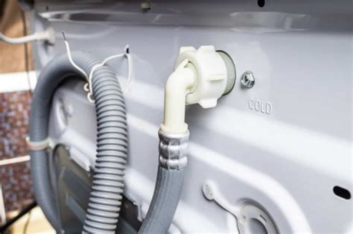 How do I clear my washing machine drain pipe?