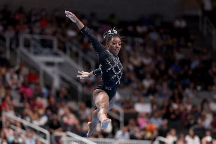 How many hours a day does Simone Biles train?