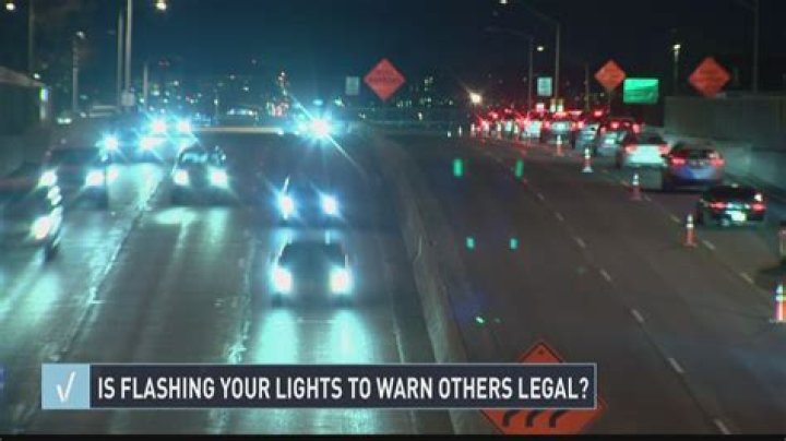Is it illegal to flash your headlights in Georgia?