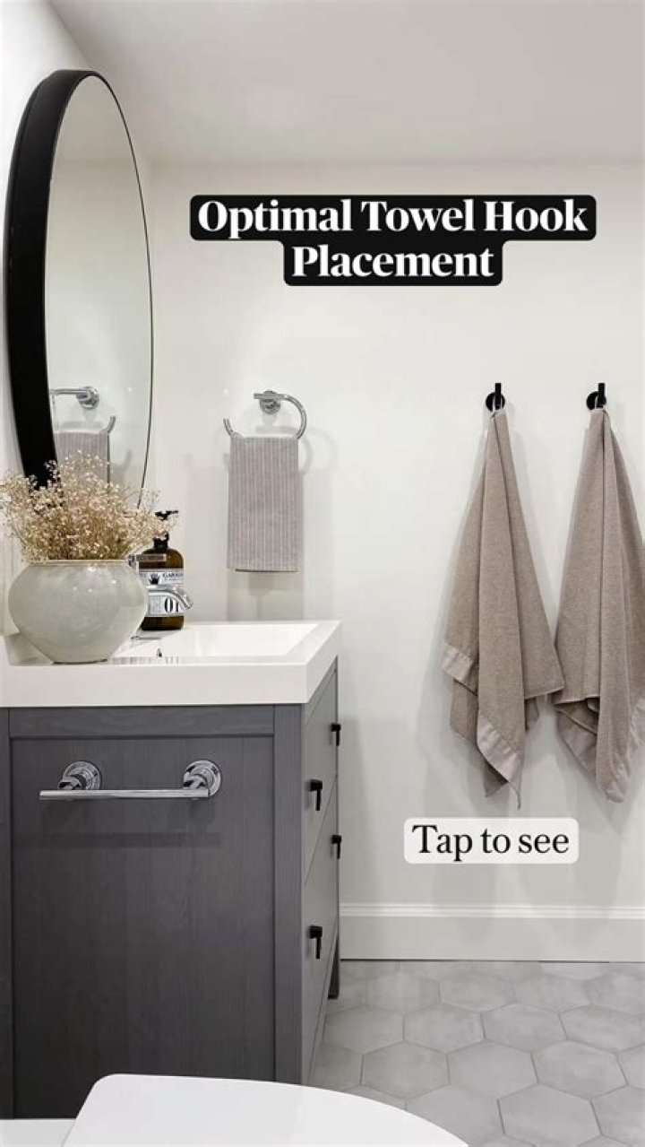 Where should a robe hook be placed in a bathroom?