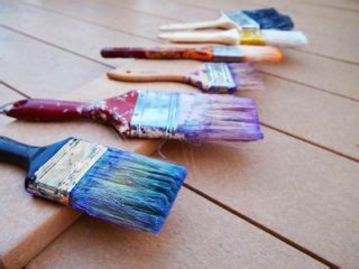 Where should you wash paint brushes?