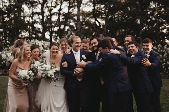 Who normally sits with the bride and groom?