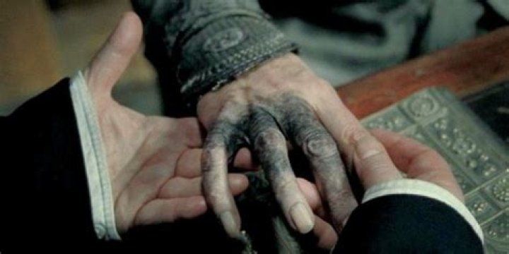 Why did Dumbledore's hand turn black?