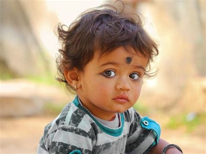 Why do Indian babies have a black dot on their forehead?