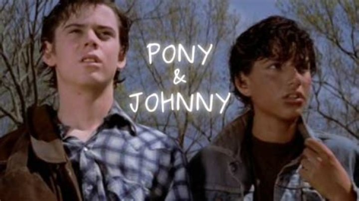 Why does Dally hit Ponyboy on the back?