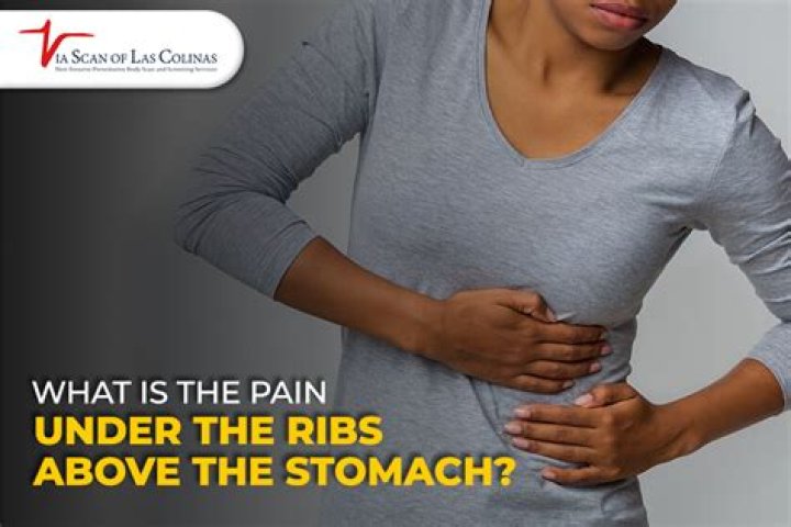 Why is my stomach hard under my ribs?